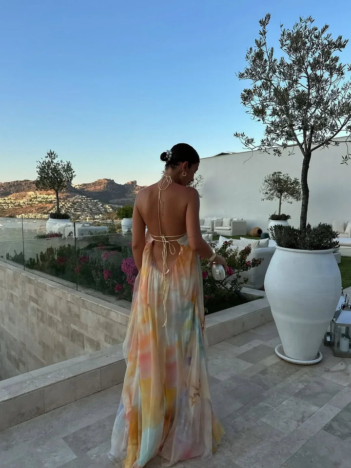 Elegant women's party maxi dress, sleeveless, with an open back and eye-catching watercolor print.