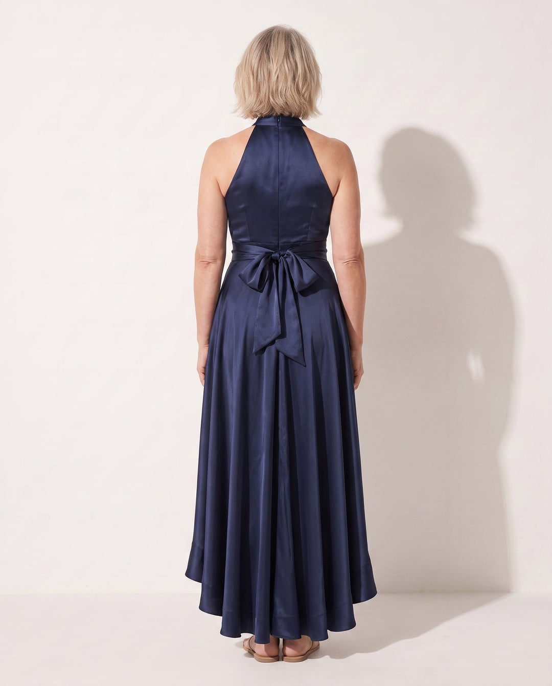 Formal women's evening gown: elegant halter neck maxi dress with graceful ruffles, perfect for special occasions.