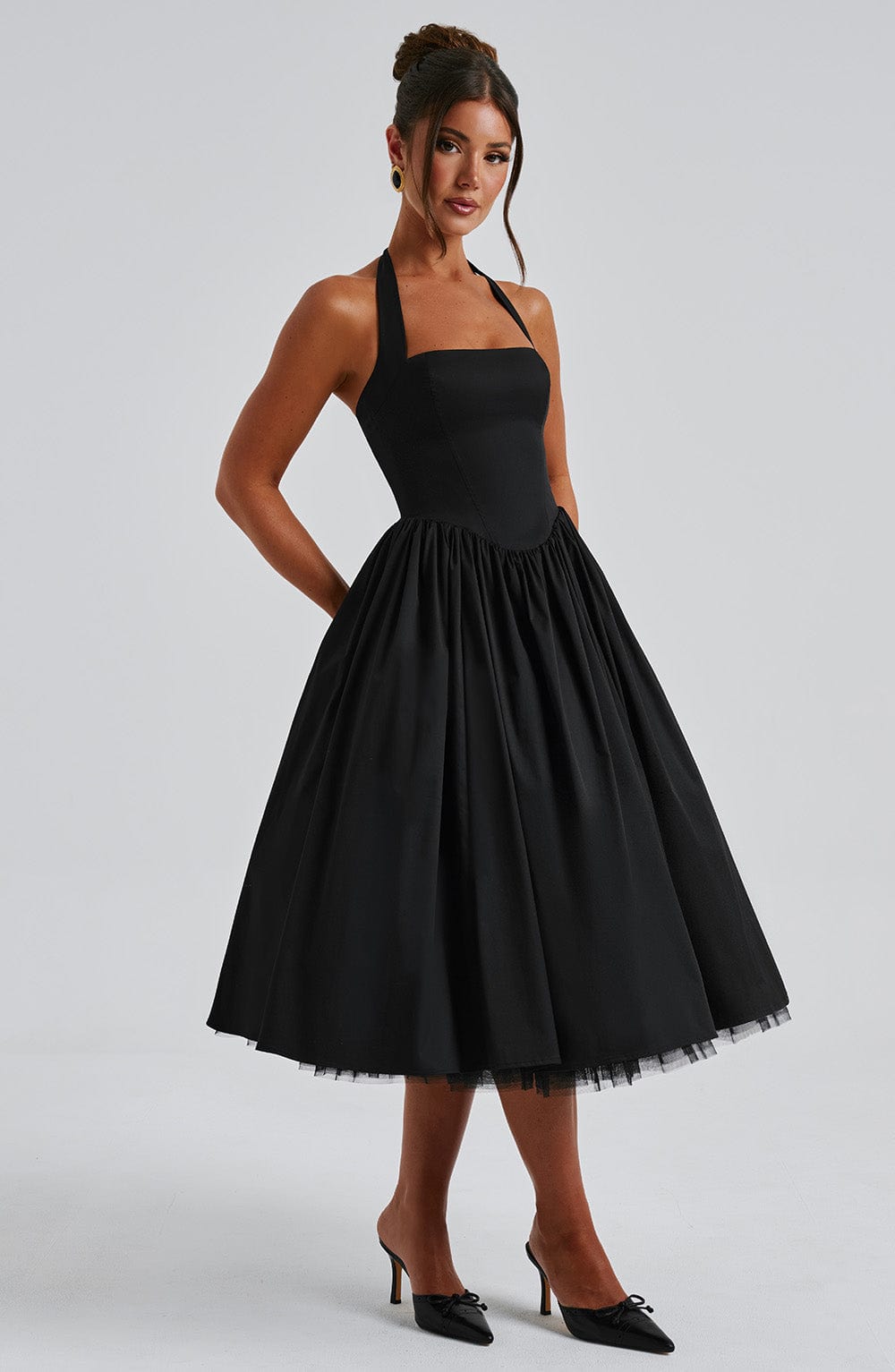 Stylish women's halter neck midi dress with pleated skirt & smocked back, a versatile party outfit.