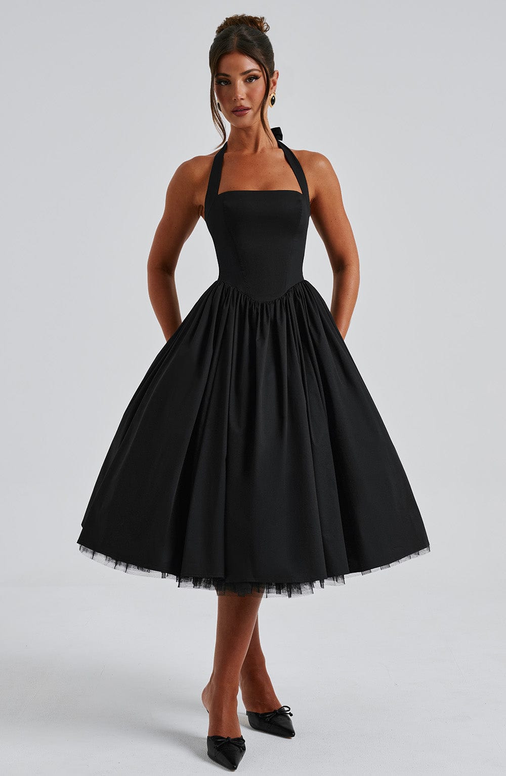 Versatile women's elegant halter midi dress with a comfortable smocked bodice and flowing pleats.