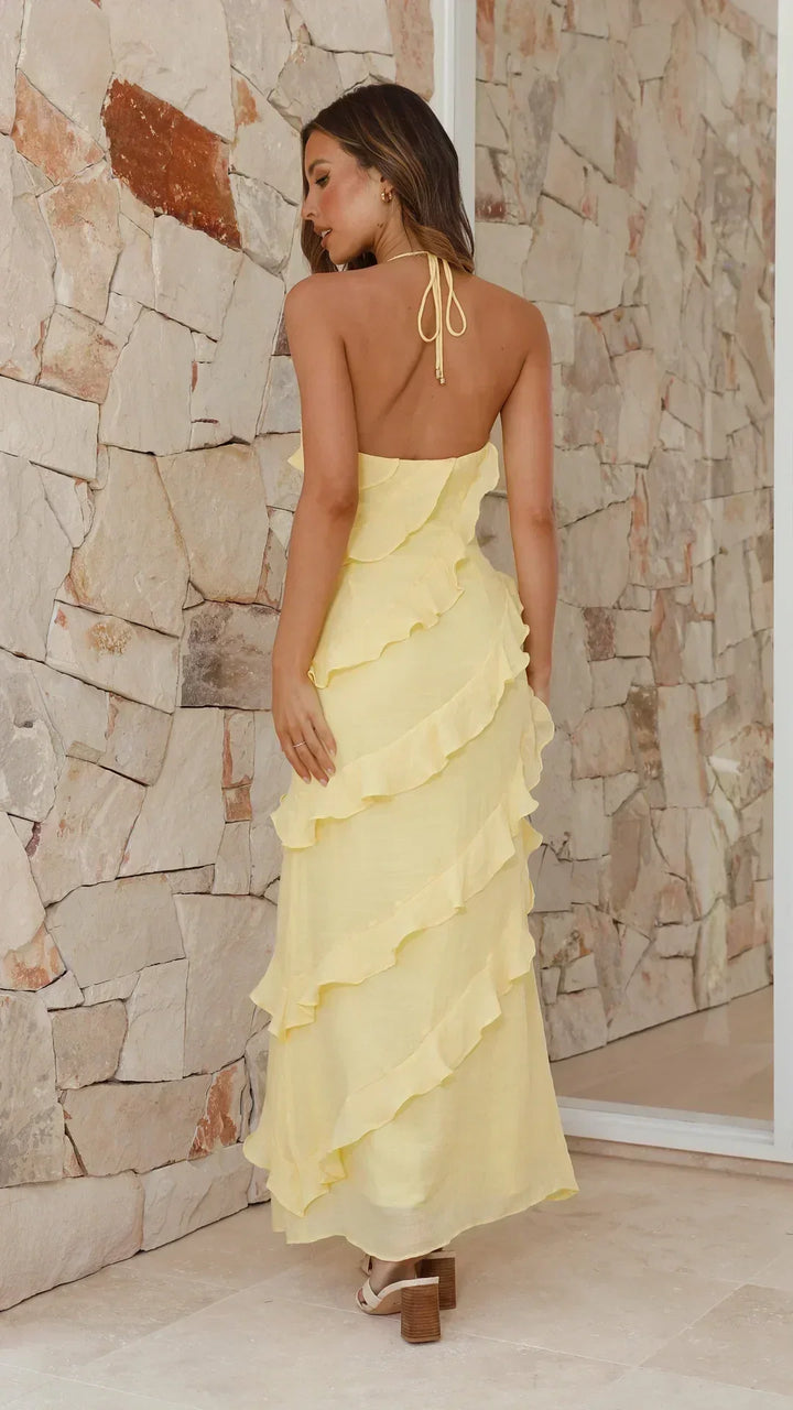 Stylish women's sleeveless halter maxi dress with tiered ruffles, ideal for evening events and occasions.