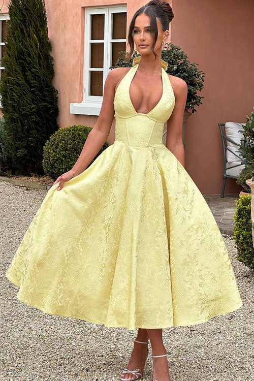 Sophisticated sleeveless maxi dress with halter V-neck and jacquard pattern.