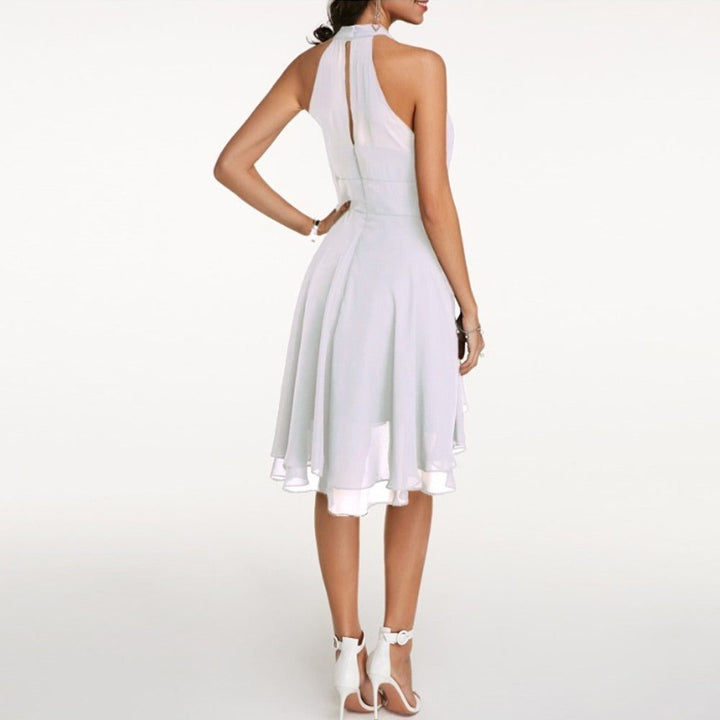 Sophisticated women's knee-length halterneck A-line dress with a graceful ruffled hem, perfect for wedding guests.