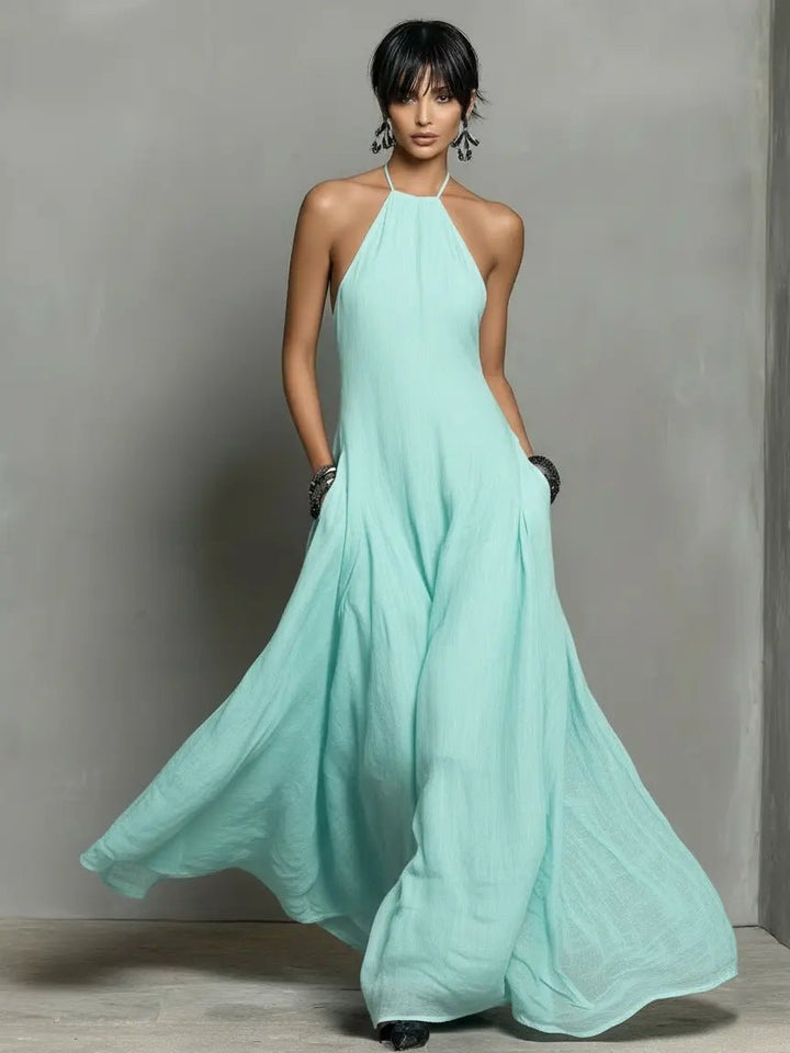 Flowy summer maxi dress for women with elegant halterneck, sleeveless design for comfort.