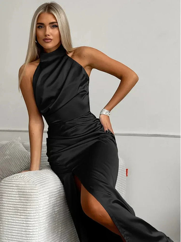 Glamorous women's halterneck maxi dress with a flattering side split, designed for wedding guests & formal events.