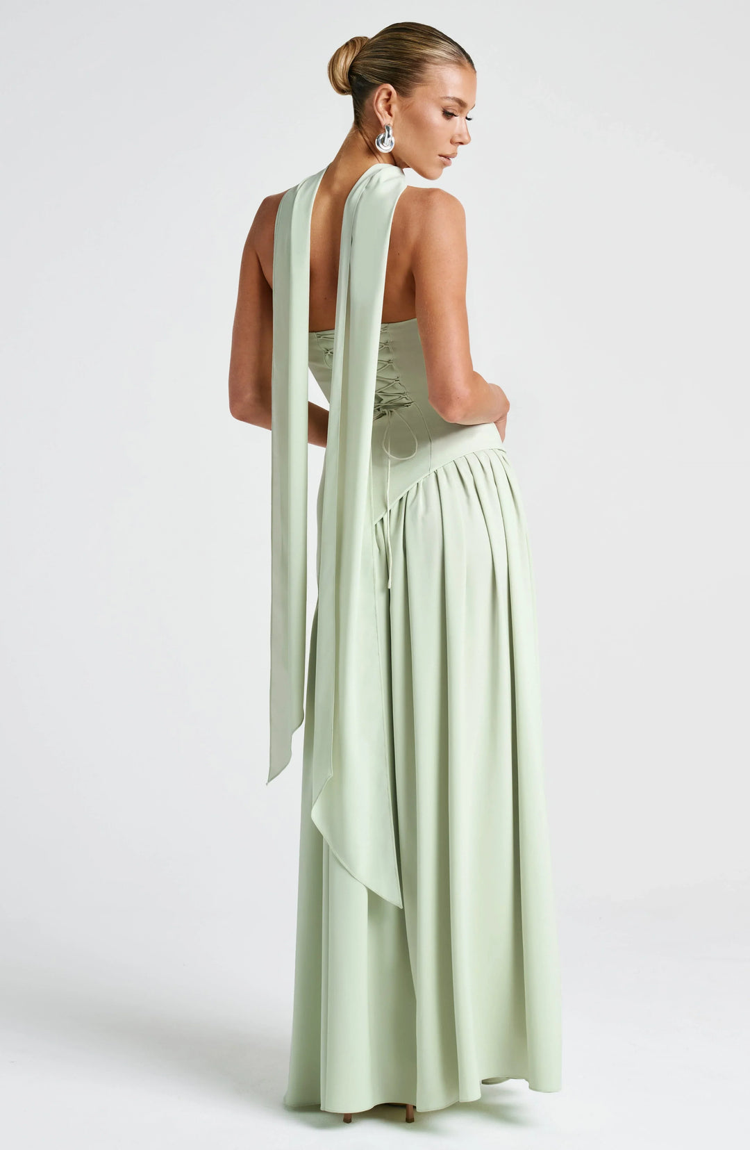 Make a statement in this halterneck maxi dress with high split, an elegant evening gown.