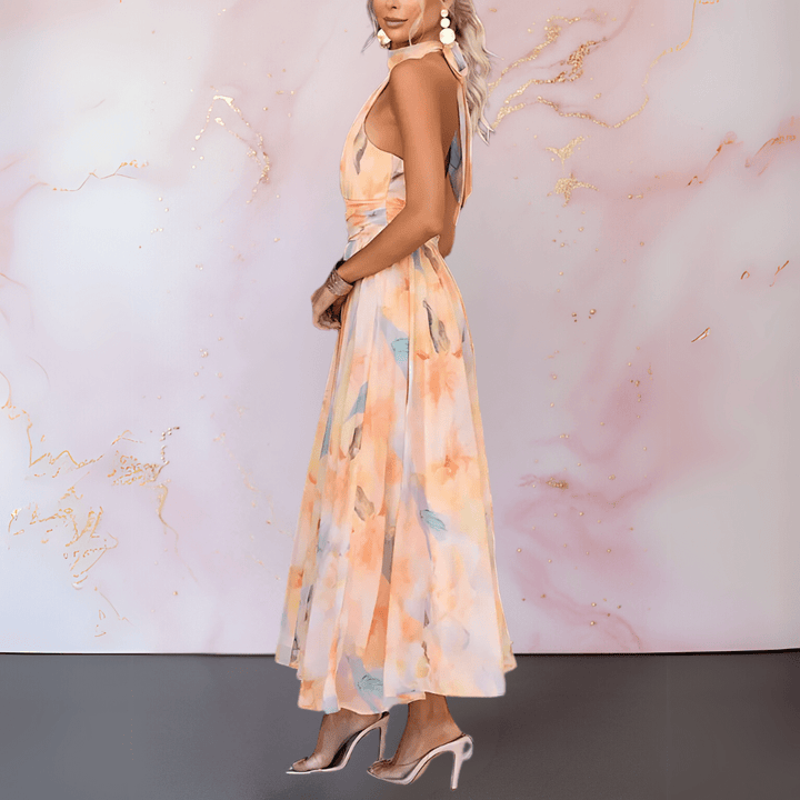 Fashionable women's watercolor print halterneck maxi dress, offering a flowing fit for chic summer style.