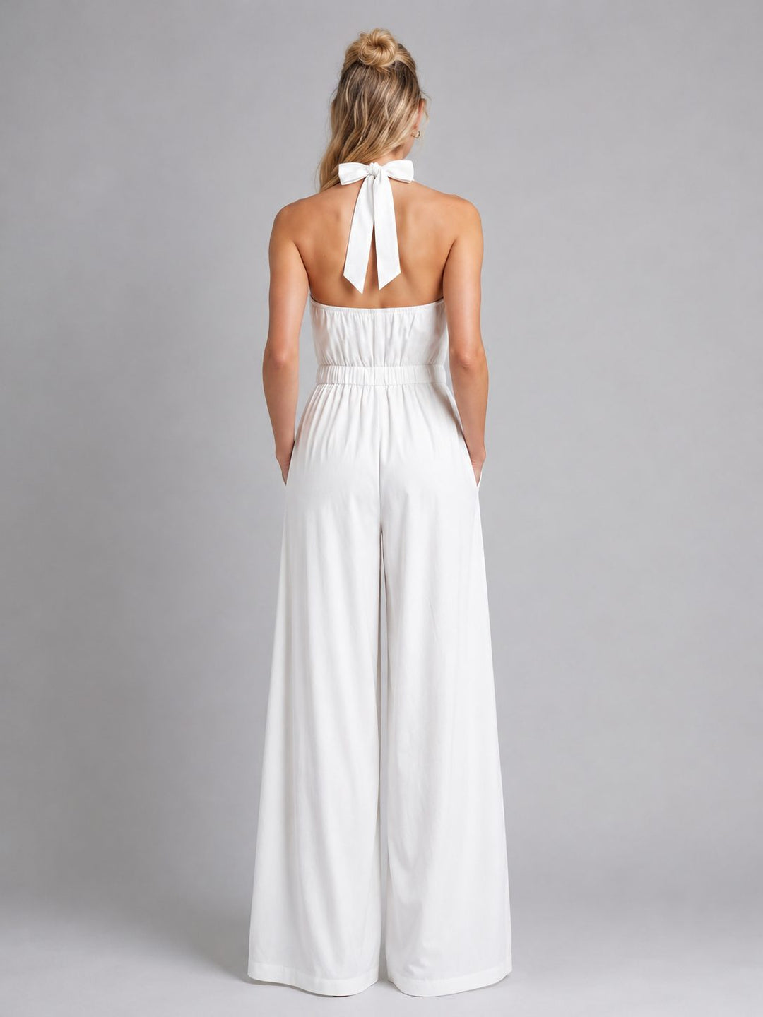 Chic women's sleeveless halterneck jumpsuit with wide-leg pants for a comfortable, flowy fit.