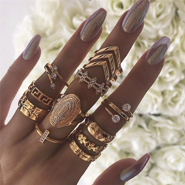 Woman's hand wearing an elegant stackable silver ring set, handmade jewelry, chic style.