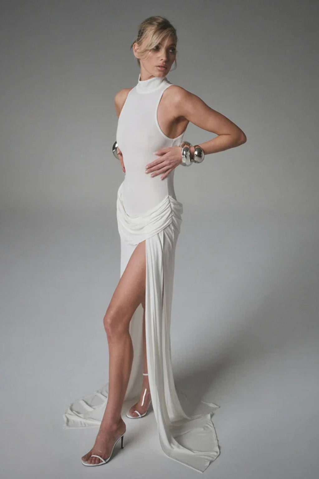 Graceful sleeveless high neck maxi dress with a side split, perfect for elegant wedding guest attire.
