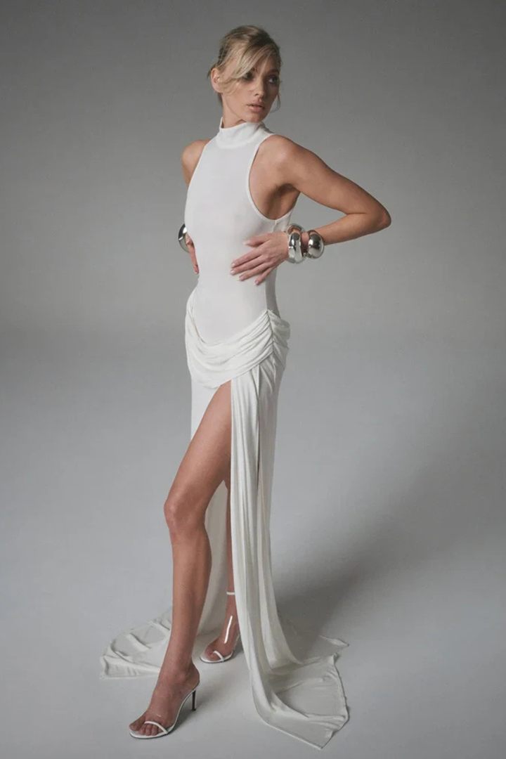 Graceful sleeveless high neck maxi dress with a side split, perfect for elegant wedding guest attire.