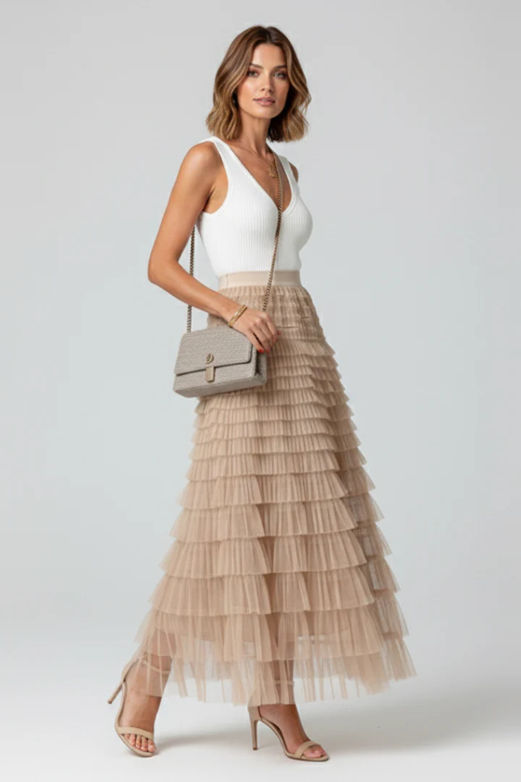 Beautiful black high-waist midi skirt for women with elegant tiers, offering a flowing style for any event.