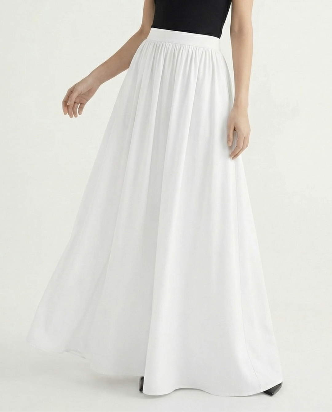 Flowy high-waisted midi skirt for women, elegant and versatile, moving beautifully with every step.