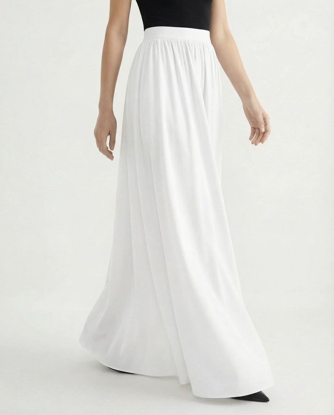 Adaptable women's high-waisted flowing skirt, elegant midi length perfect for day-to-night versatile styling.