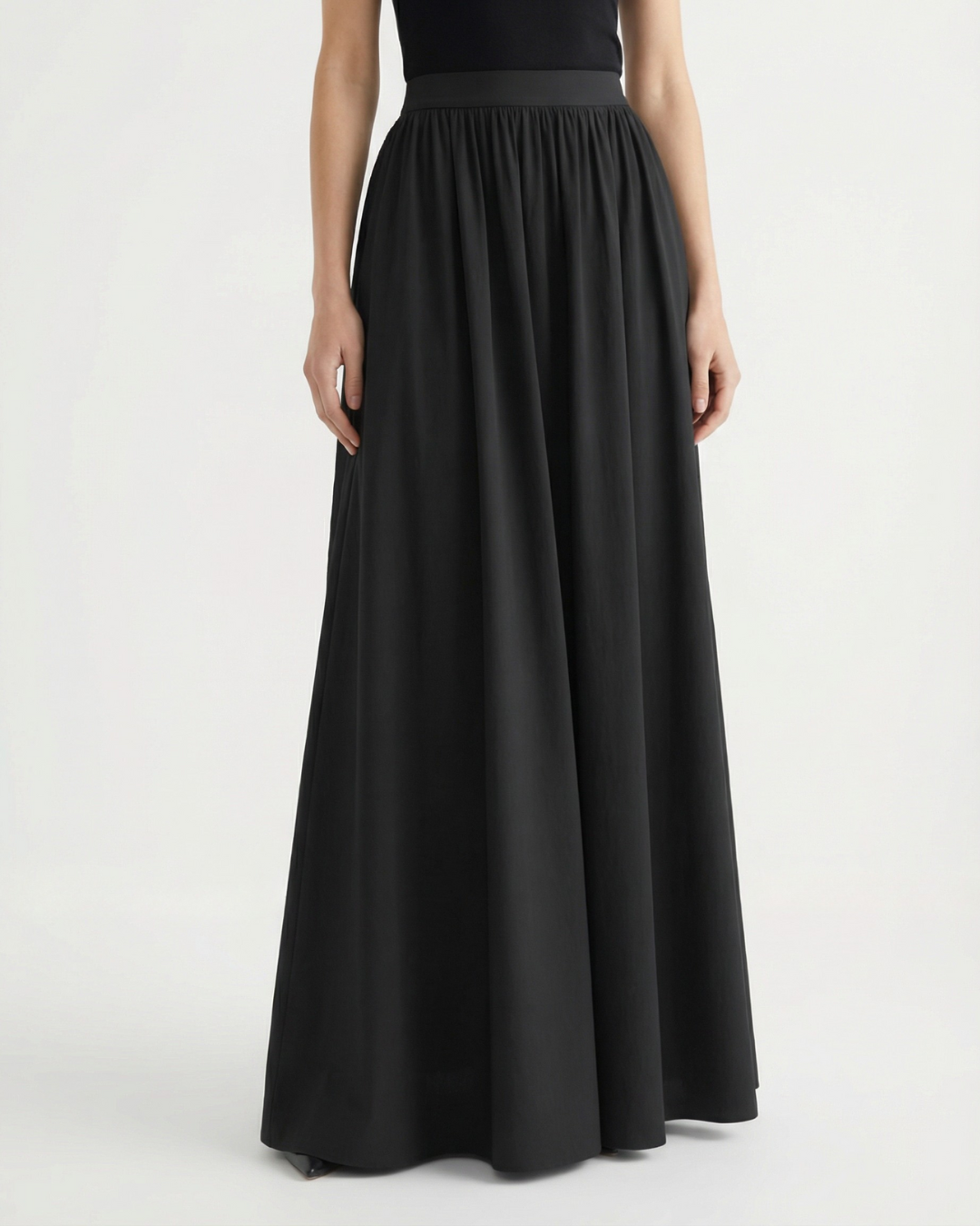 Chic women's high-waisted A-line skirt with a flowing midi length, ideal for elegant everyday fashion.