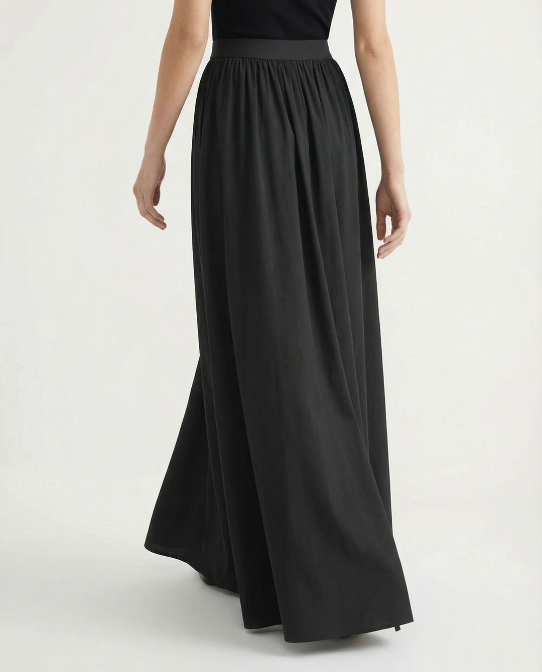 Solid color high-waisted flowing skirt, an elegant midi for women, perfect for versatile fashion styles.