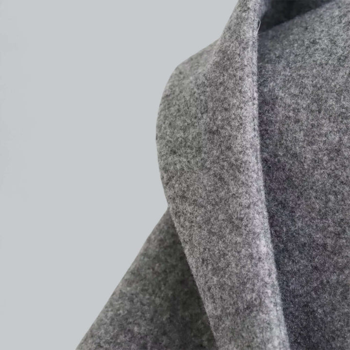 Detail of the hooded women's long trench coat, showing the durable fabric and refined finish.