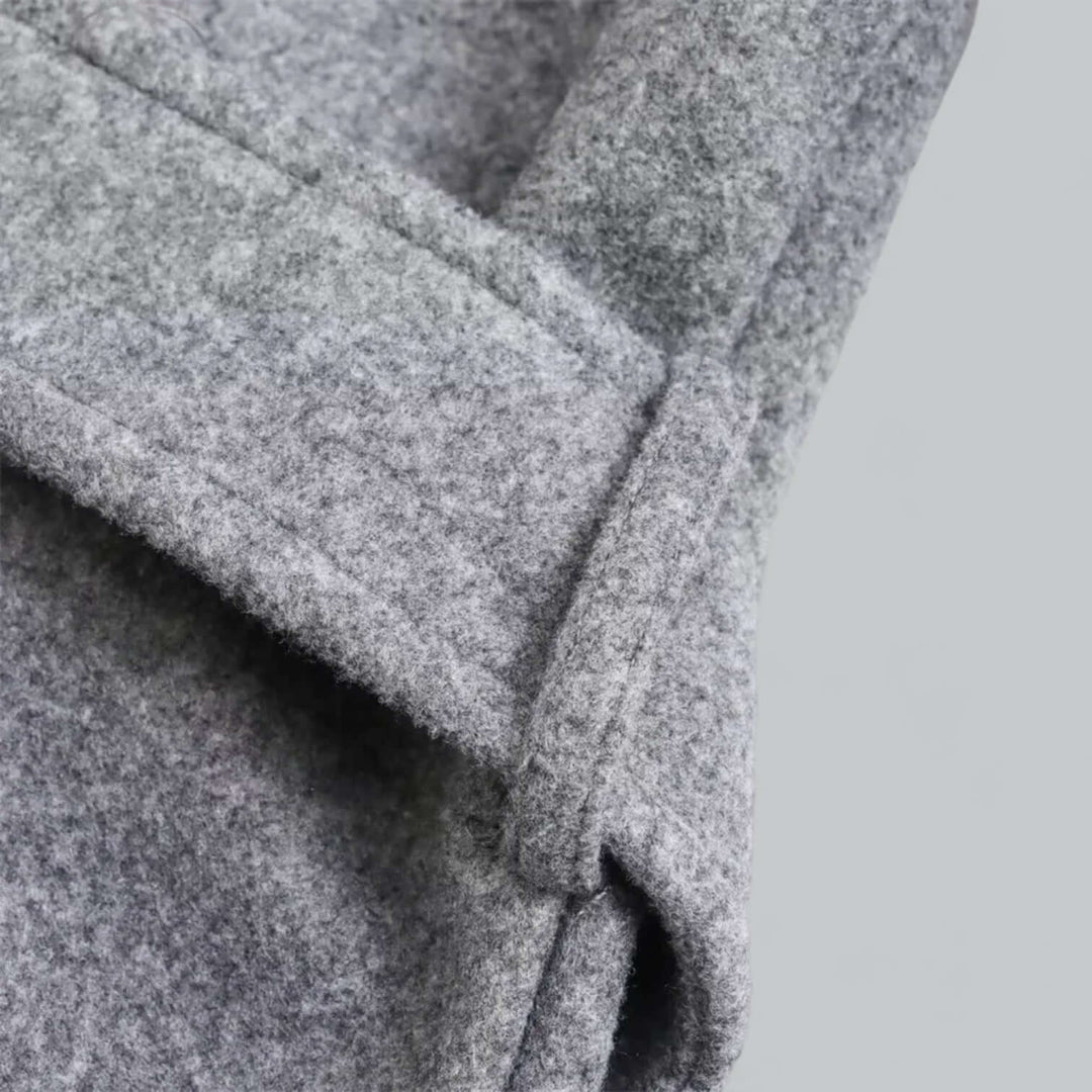 Women's long hooded trench coat in motion, illustrating its flowing design and comfortable fit.
