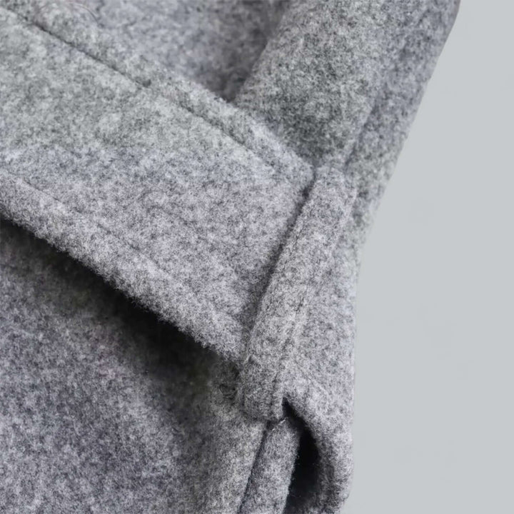 Women's long hooded trench coat in motion, illustrating its flowing design and comfortable fit.