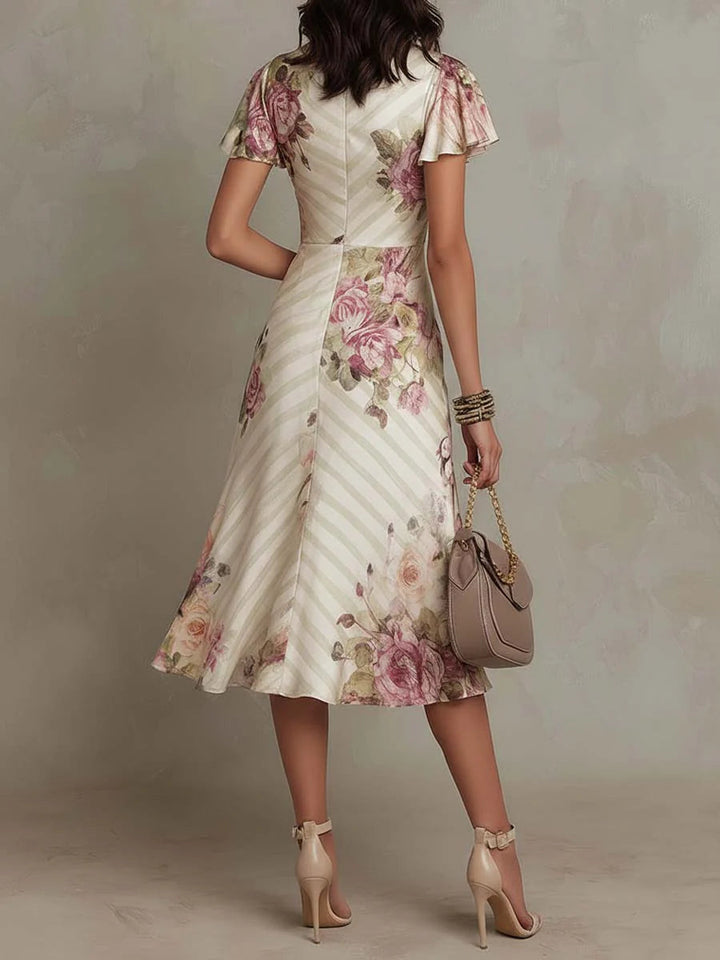 Beautiful ivory floral print midi dress for women, featuring flattering ruching & a stylish V-neck design.
