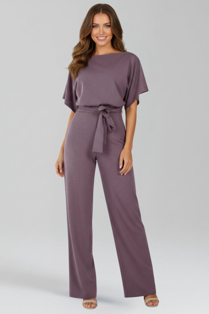 Formal women's jumpsuit featuring an elegant tie waist and a stylish, flowing wide-leg silhouette.