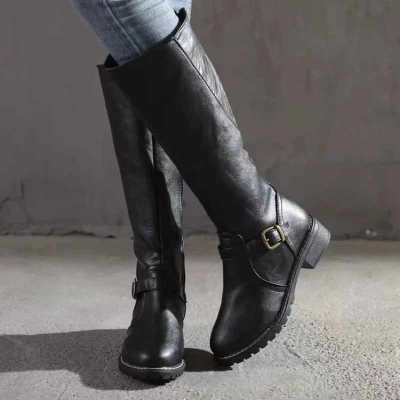 Stylish women's tall knee-high boots, elegant design. Perfect classic footwear for fall/winter outfits.