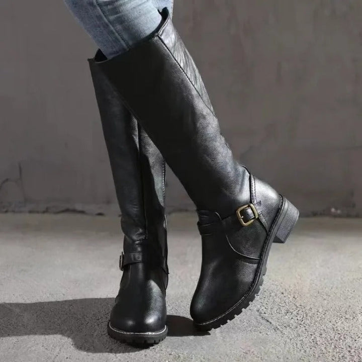 Stylish women's tall knee-high boots, elegant design. Perfect classic footwear for fall/winter outfits.