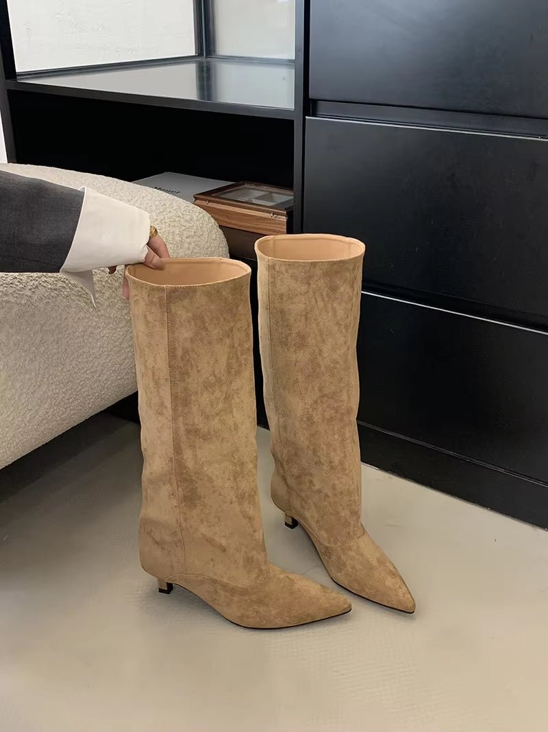 Sophisticated women's knee-high boots with a sleek kitten heel & pointed toe, enhancing any elegant outfit.