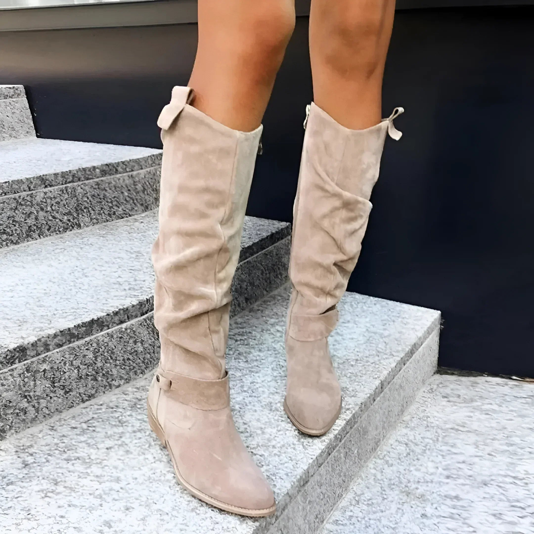Fashionable women's knee-high boots. Durable block heel and decorative strap detail enhance winter outfits.
