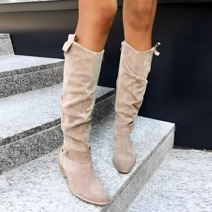 Fashionable women's knee-high boots. Durable block heel and decorative strap detail enhance winter outfits.