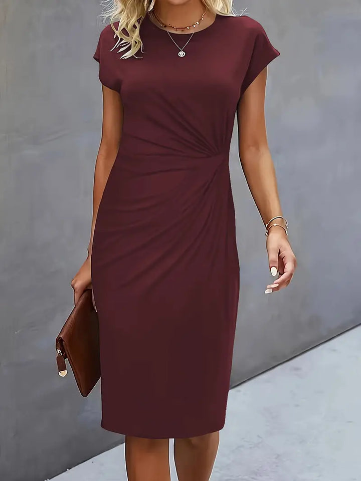 Elegant knee-length sheath dress for women, ruched waist detail, versatile for formal or party.