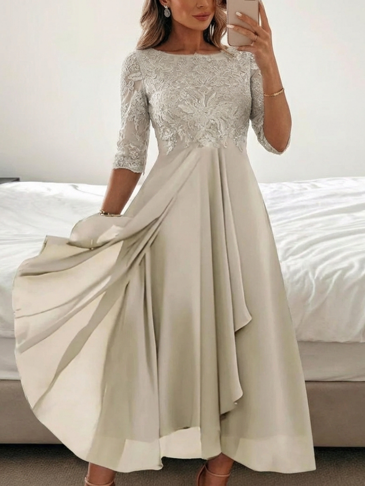 Beautiful women's lace midi dress with delicate patterns and stylish three-quarter sleeves.