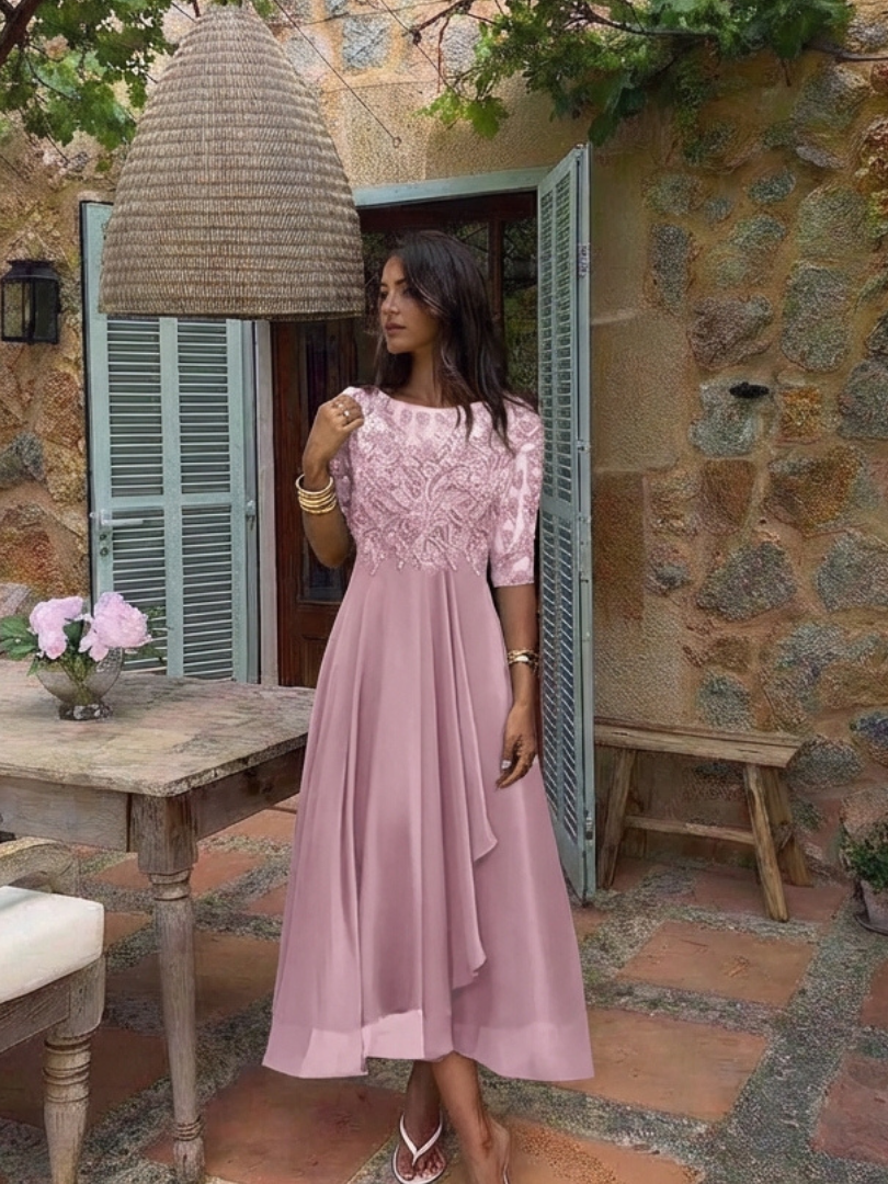 Close-up of elegant lace detailing on a women's midi dress with three-quarter sleeves.