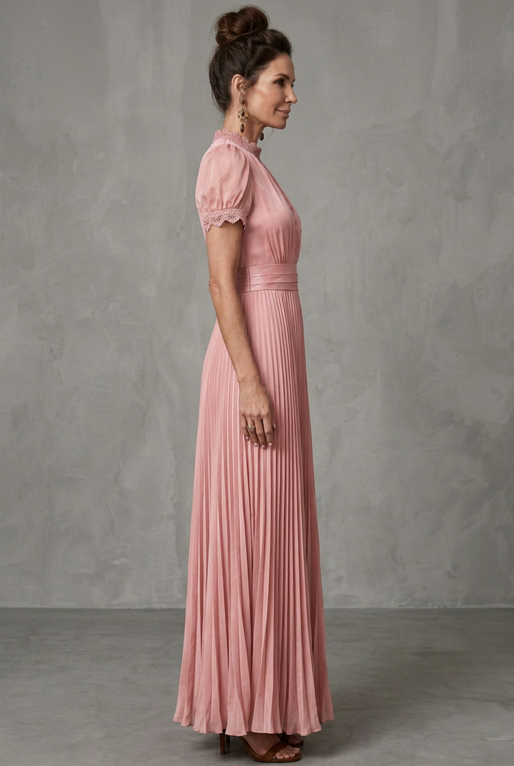Feminine A-line maxi dress for women, featuring delicate lace trim, pleats, & high neckline. Wedding guest attire.