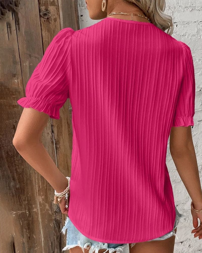 Women's summer V-neck shirt featuring delicate lace details, a versatile dressy top.