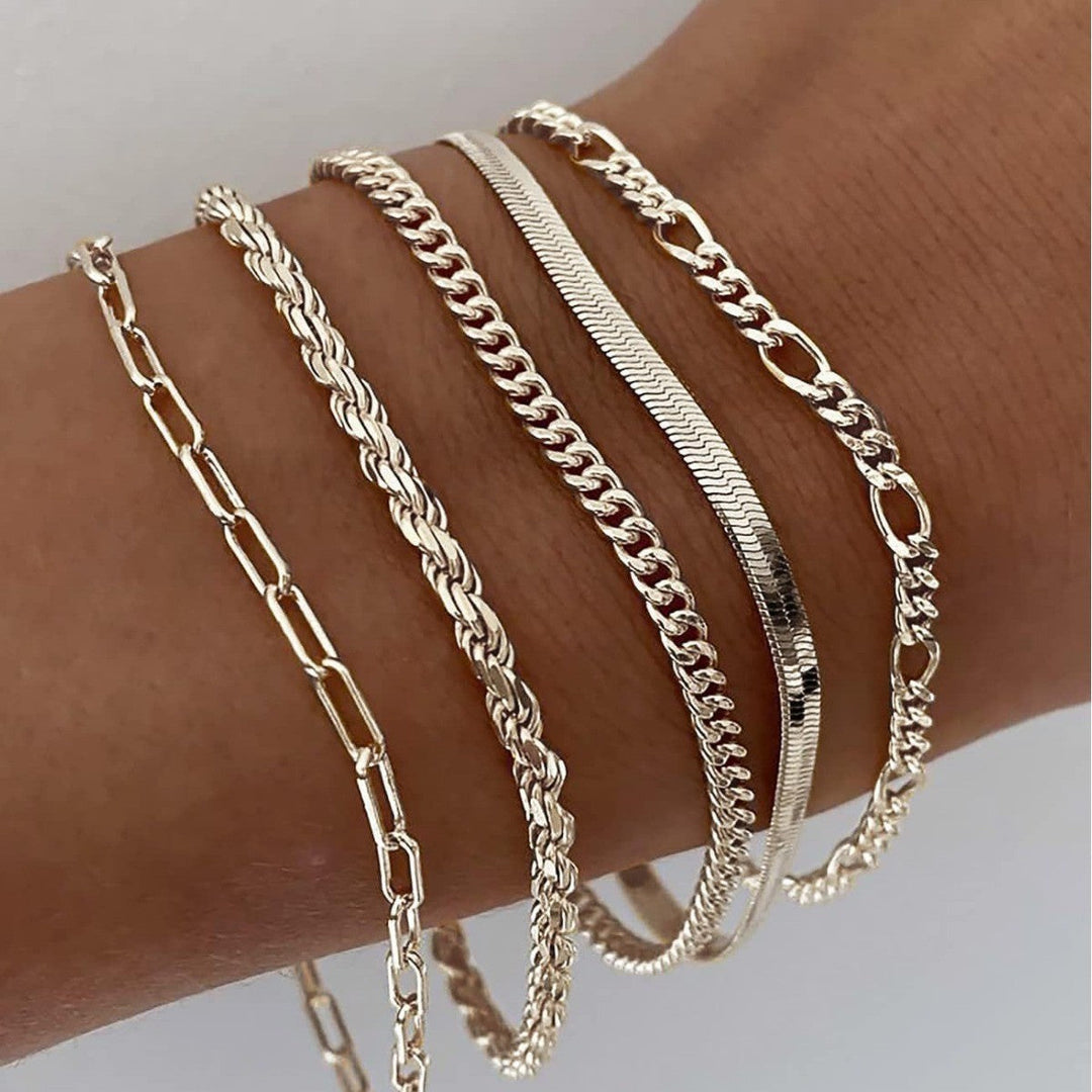Stylish women's layered gold and white gold bracelet set, perfect elegant jewelry for a gift.