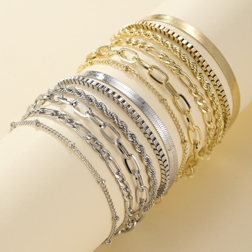 Close-up of elegant women's layered bracelet set featuring sparkling gold and white gold finishes.