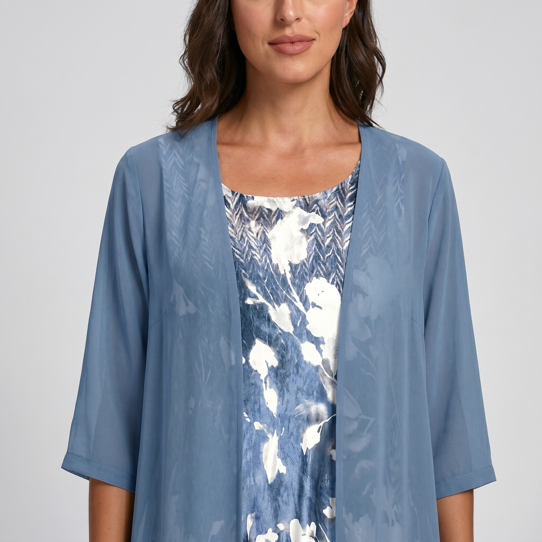 Close-up of the flowing fabric on a women's layered midi dress. Open front detail.
