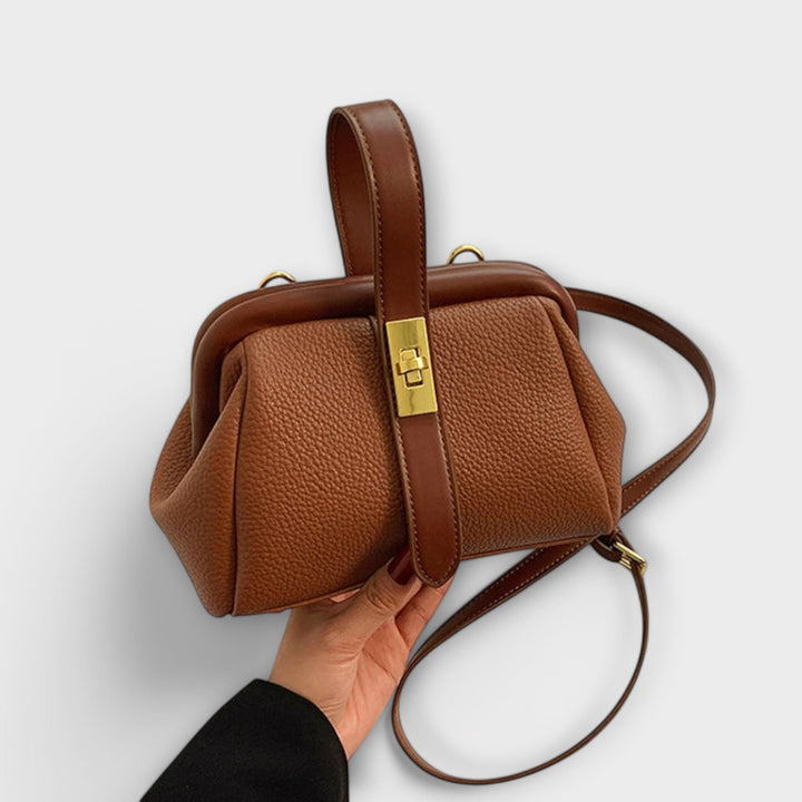 Elegant women's leather mini handbag with a secure turn lock closure, perfect for everyday style.