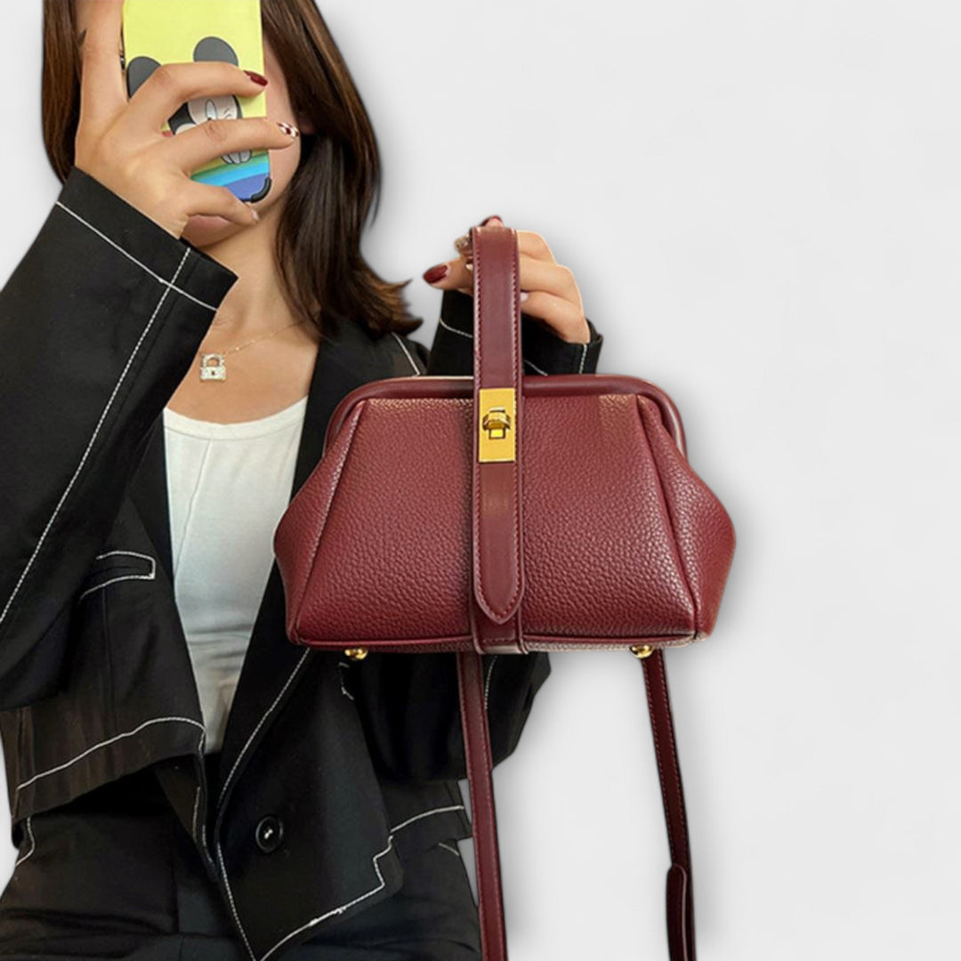 Everyday black leather mini handbag for women, featuring a sleek design and secure turn lock.