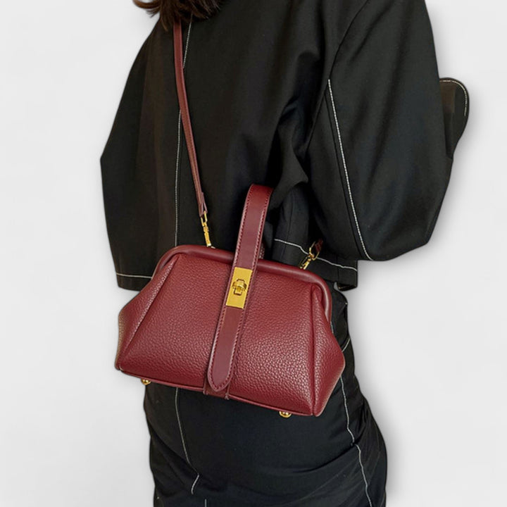 Sophisticated khaki leather mini bag with a turn lock, suitable for a professional or casual look.
