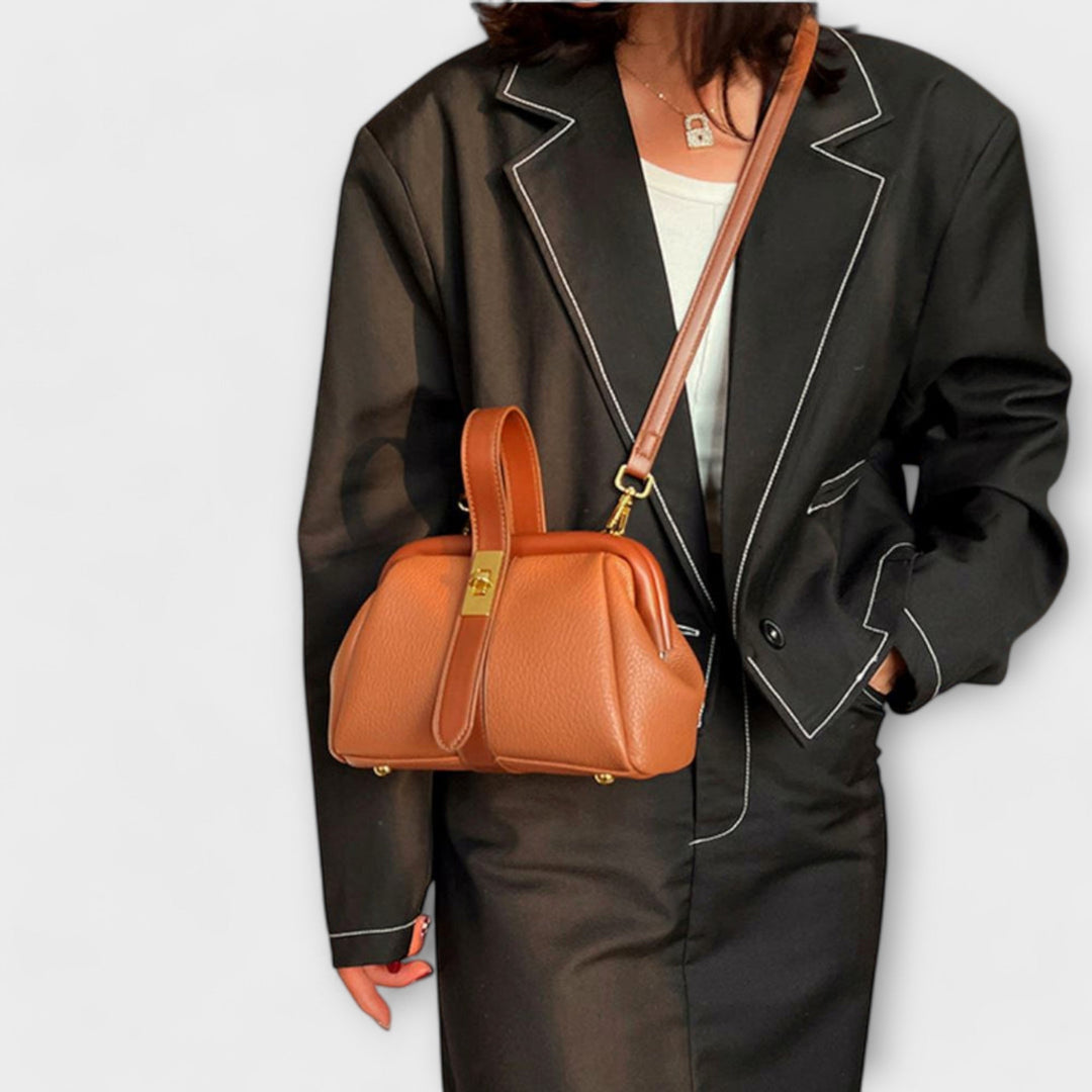 Versatile brown leather shoulder bag for women with an elegant turn lock and spacious interior.
