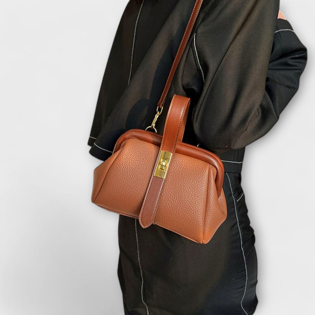 Compact khaki leather crossbody bag for women, designed with a fashionable turn lock detail.