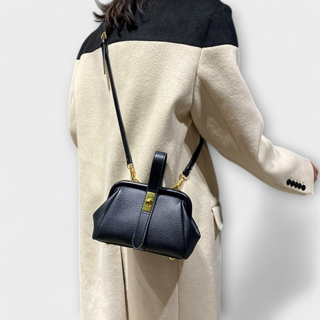 Chic brown leather mini bag with a secure turn lock, ideal for an elegant evening or daily use.