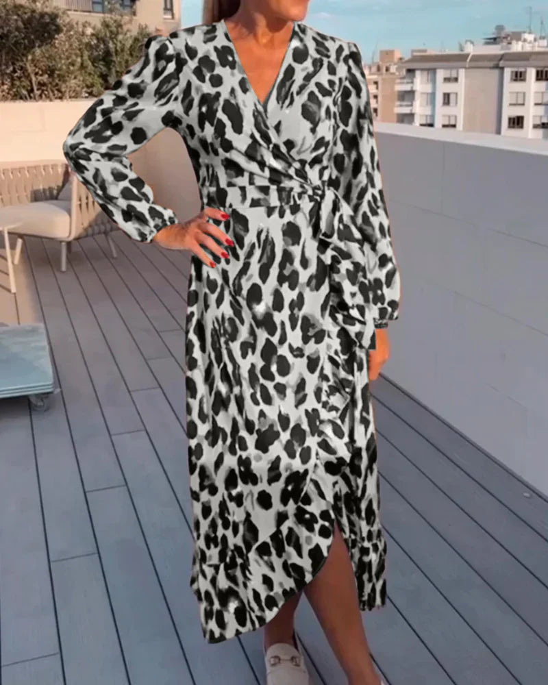 Stylish women's animal print midi dress. Elegant leopard pattern, V-neck, A-line cut. Fashionable occasion wear.
