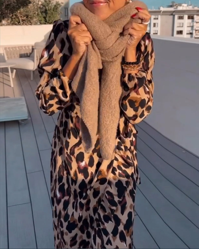 Chic women's animal print midi dress with an elegant leopard pattern. V-neck, A-line, and long sleeves.