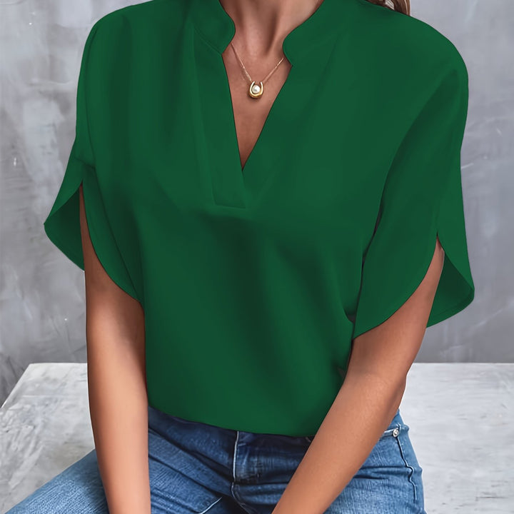 Women's lightweight blouse styled with trousers for a chic office look.