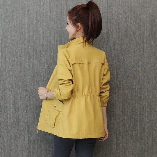Elegant women's lightweight waterproof trench coat, perfect for spring & fall rain. Versatile weather-resistant outerwear.