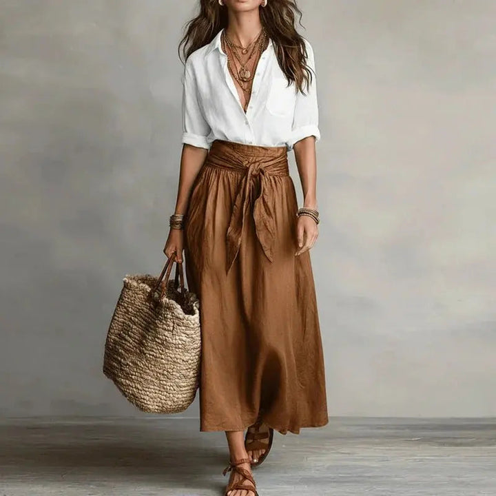 Stylish two-piece women's outfit: button-down linen top & matching midi skirt for casual chic look.