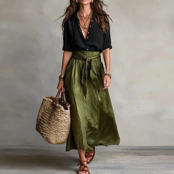 Chic women's linen two-piece set featuring a long-sleeve button-down top and a flowy midi skirt.